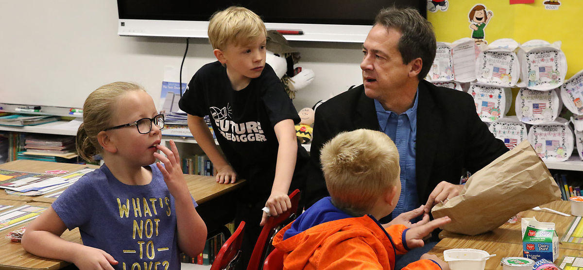 Picture of students eating with governor Bullock